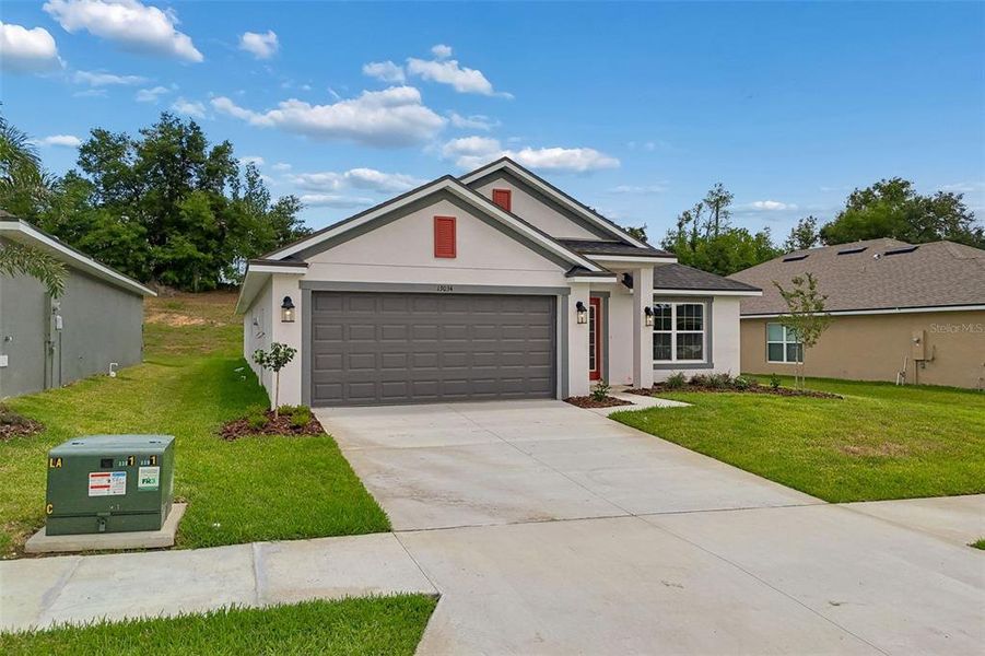 Front exterior of a new home in Abbey Glen, Dade City, FL, highlighting curb appeal (Image 28).
