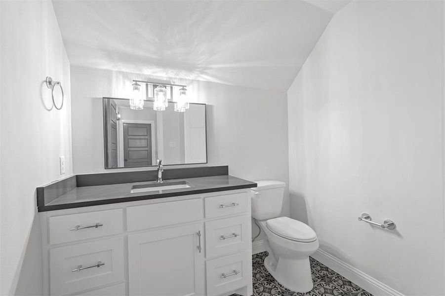 Bathroom featuring toilet, tile floors, and large vanity