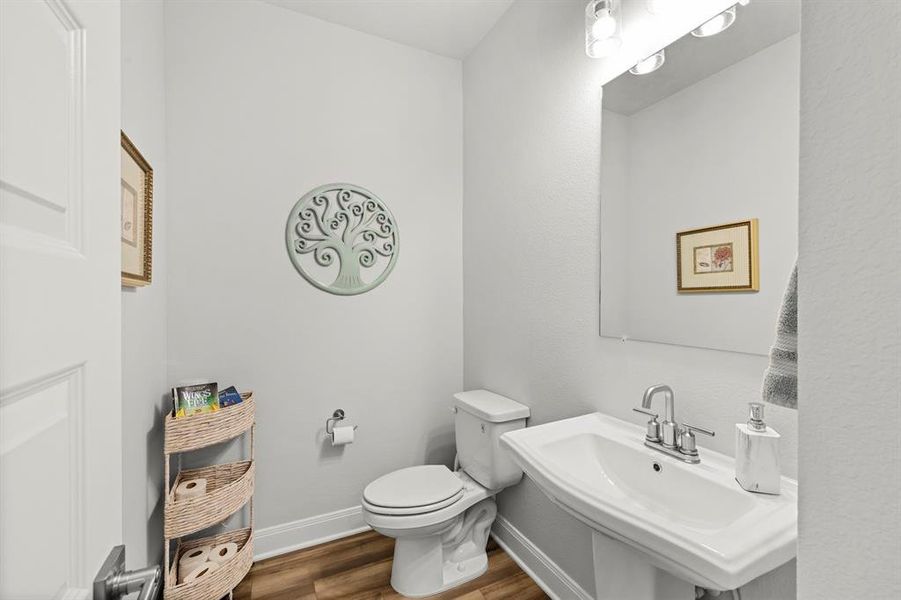 Bathroom with dark wood finished floors and baseboards Bathroom with dark wood finished floors and baseboards