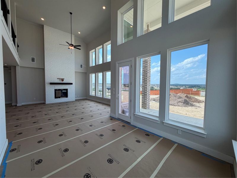 Family Room with soaring ceiling & fireplace