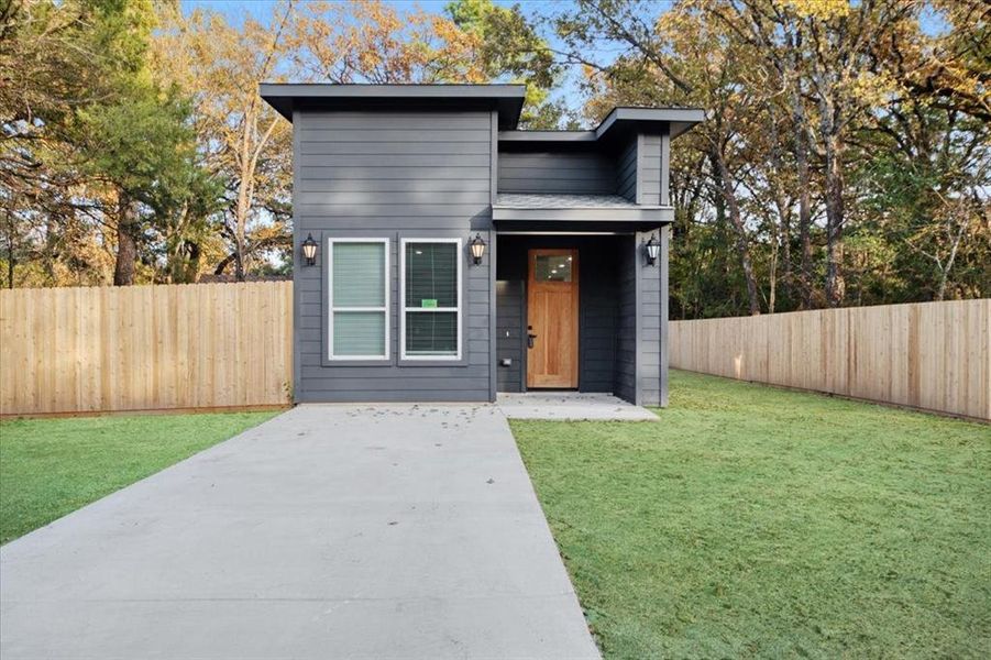 Contemporary home featuring a front lawn