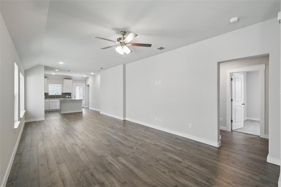 Unfurnished living room with a ceiling fan, dark wood finished floors, and recessed lighting Unfurnished living room with a ceiling fan, dark wood finished floors, and recessed lighting