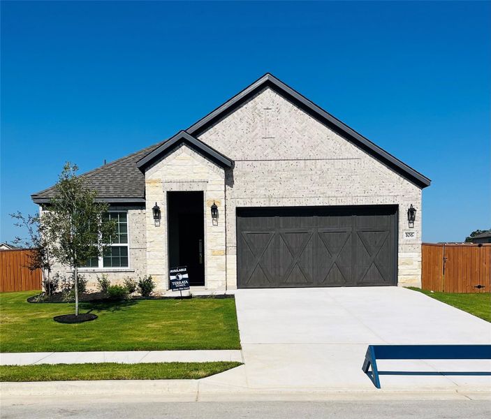 Our beautiful Kendall floor plan comes with a long driveway, a cedar garage door, and lush front yard landscaping.