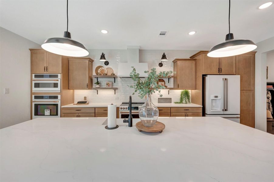 Gourmet island kitchen with light stain cabinets (*Photo not of actual home and used for illustration purposes only.)