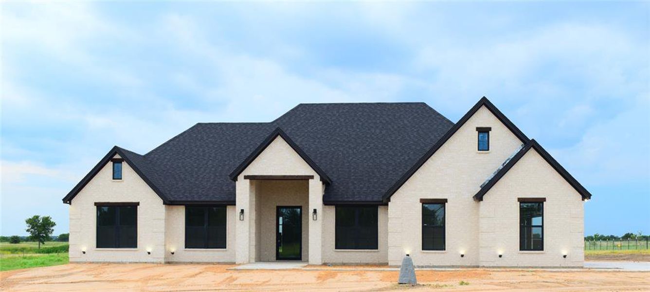 View of front facade featuring roof with shingles and brick siding View of front facade featuring roof with shingles and brick siding