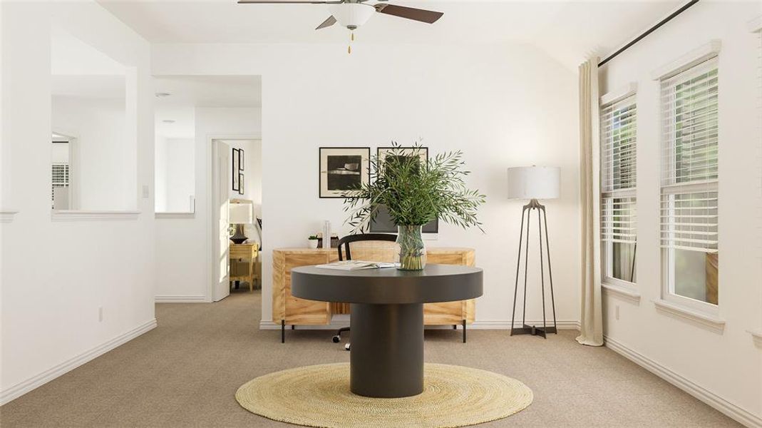 Carpeted dining area featuring lofted ceiling and ceiling fan