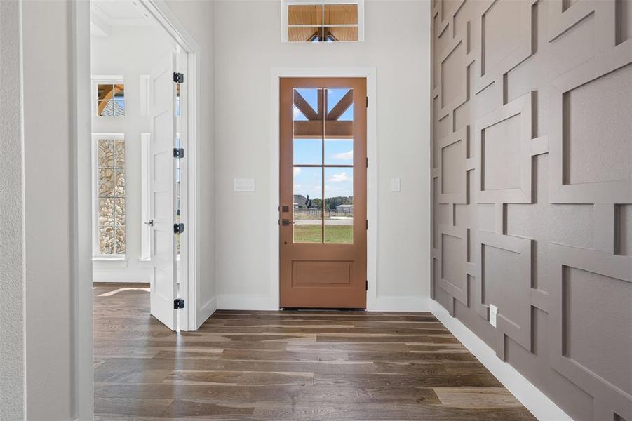 Entryway featuring wood finished floors and baseboards