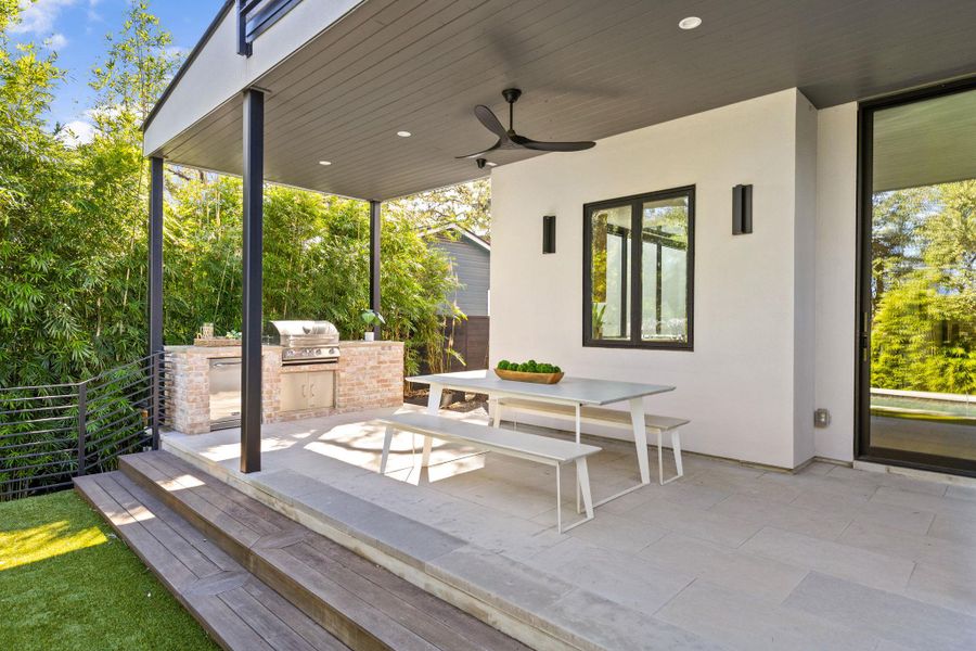View of patio / terrace with area for grilling, outdoor dining area, a ceiling fan, and a wooden deck View of patio / terrace with area for grilling, outdoor dining area, a ceiling fan, and a wooden deck