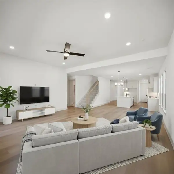 Bright open-concept living area with recessed lighting and a ceiling fan