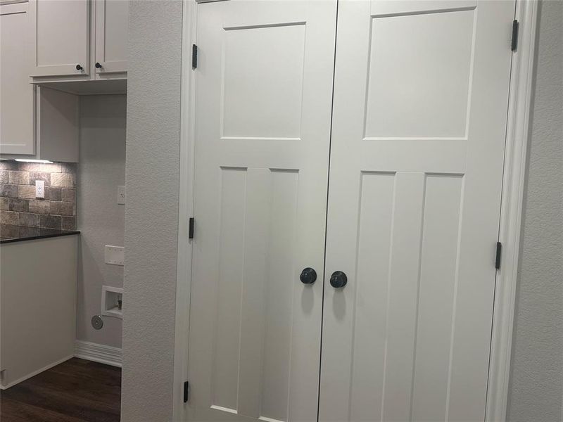 Detailed view of wood finished floors and backsplash