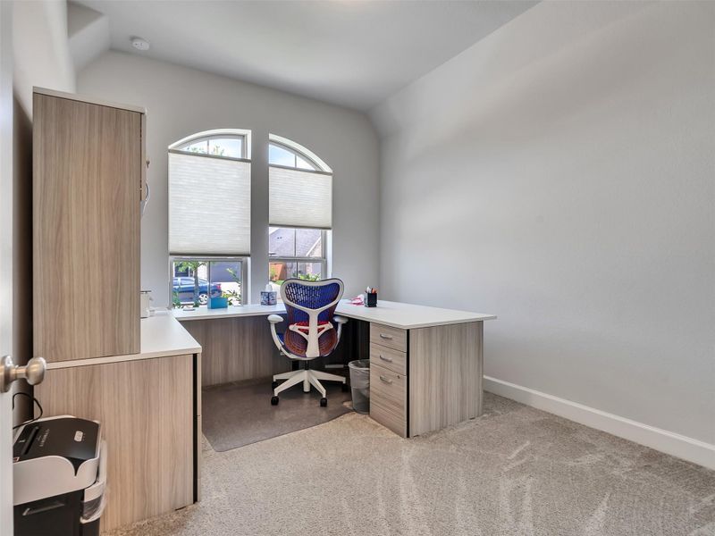 Bright and spacious home office with large arched windows, plush carpet, and modern look!!