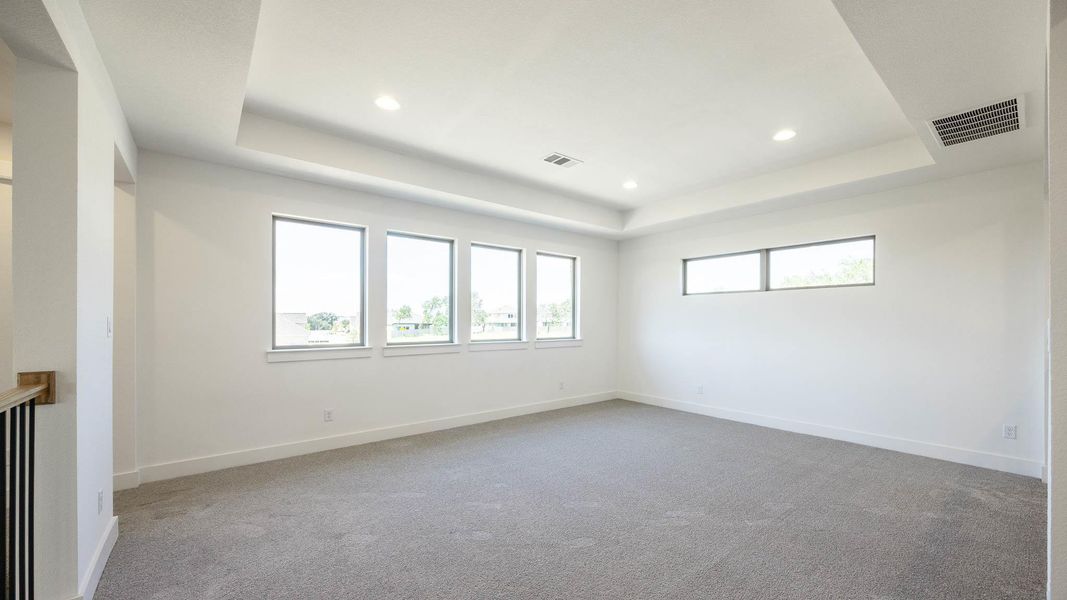 Unfurnished room with a raised ceiling, light carpet, and recessed lighting Unfurnished room with a raised ceiling, light carpet, and recessed lighting