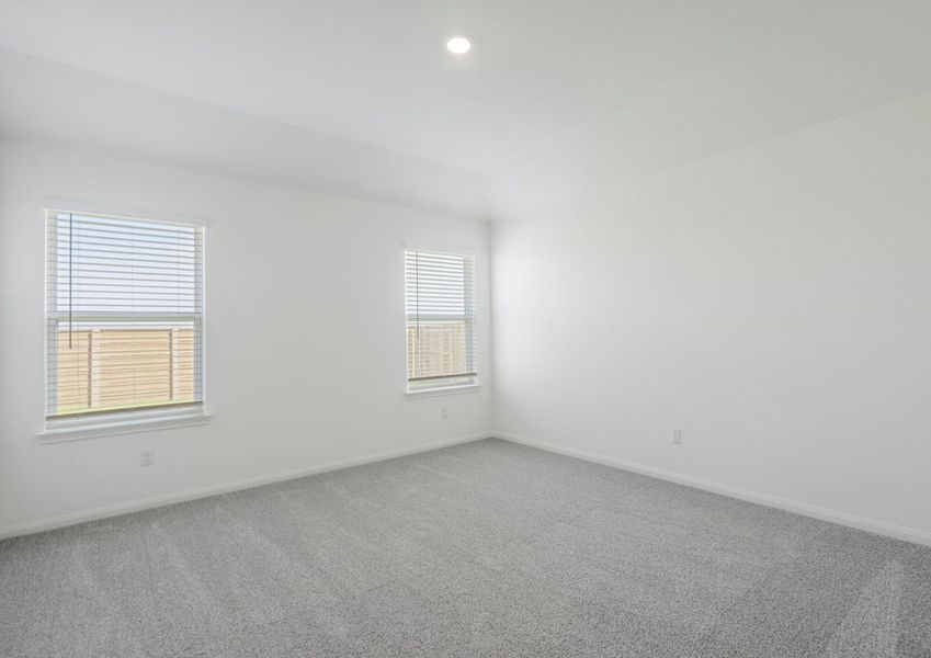Master bedroom with two windows facing the backyard