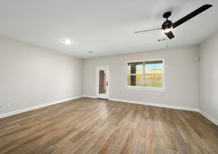 The family room has a large window that looks out to the back yard.