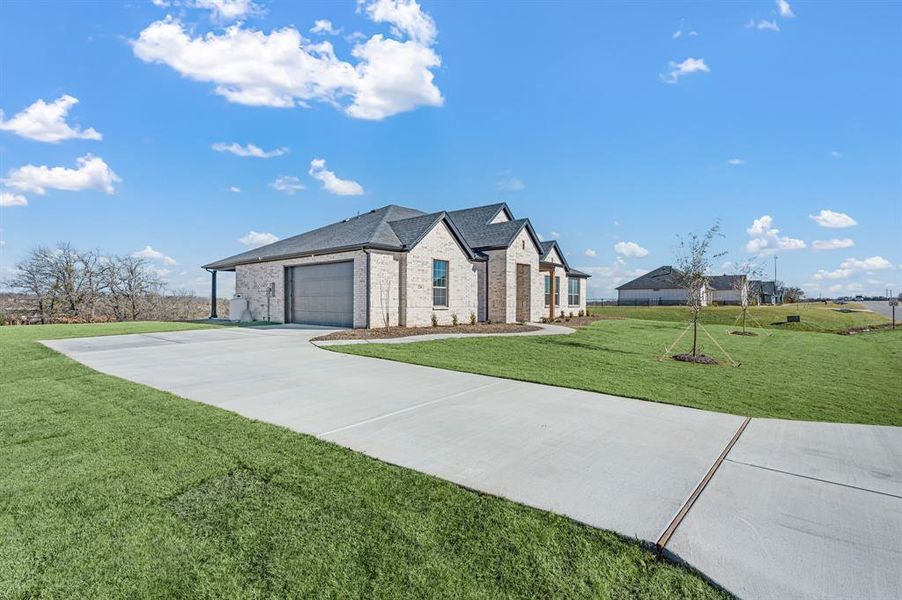 Front exterior of a new home in Rocky Top Ranch, Reno, TX, highlighting curb appeal (Image 21).