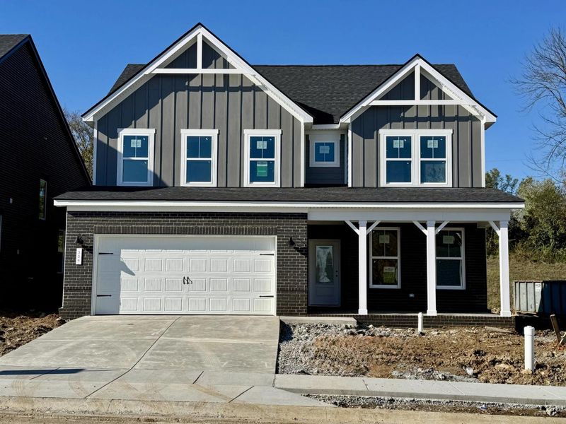 Front exterior of a new home in Woods Crossing, Gallatin, TN, highlighting curb appeal (Image 1).