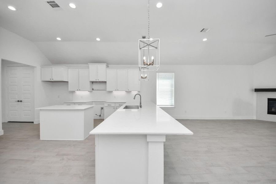 The kitchen is a culinary haven, featuring granite countertops, a tile backsplash, stainless steel appliances, 42” upper cabinets, and undercabinet lighting.