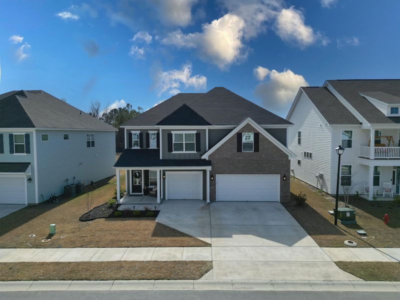 Front exterior of a new home in Hewing Farms, Summerville, SC, highlighting curb appeal (Image 26).