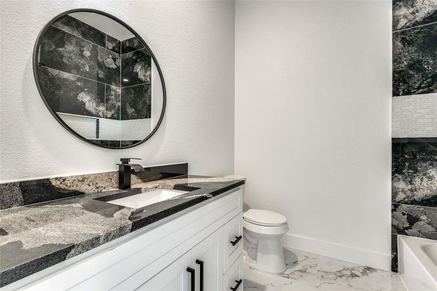 Full bathroom with  shower combination, vanity, and toilet