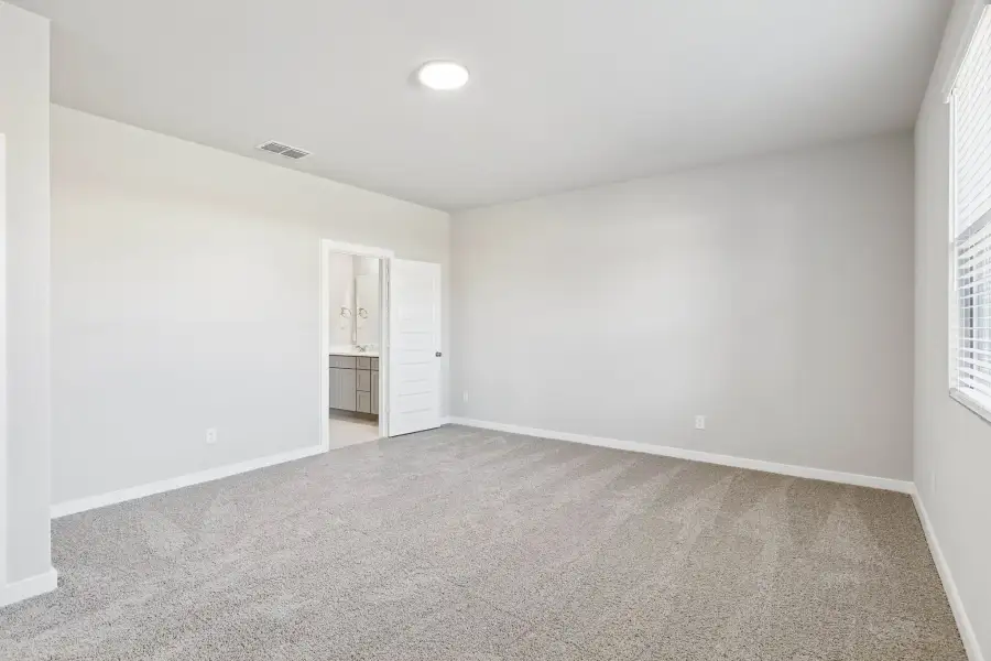 Primary Suite in the Haylee home plan by Trophy Signature Homes - REPRESENTATIVE PHOTO