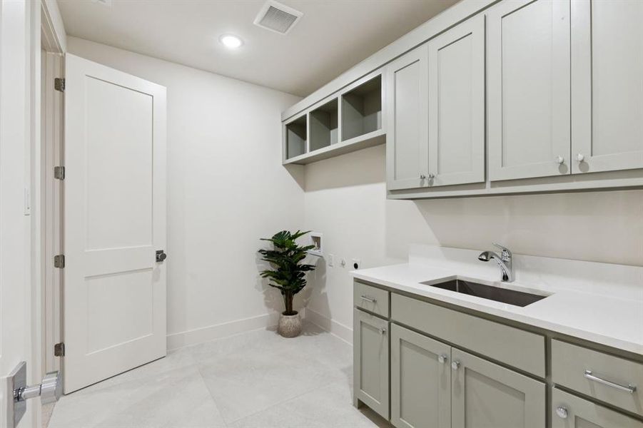 Laundry room featuring hookup for an electric dryer, cabinet space, recessed lighting, and washer hookup