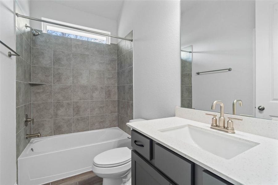 This well-appointed secondary bathroom offers exceptional functionality with stained cabinetry and light countertops with undermount sink and sleek, brushed nickel fixtures. This well-appointed secondary bathroom offers exceptional functionality with stained cabinetry and light countertops with undermount sink and sleek, brushed nickel fixtures.