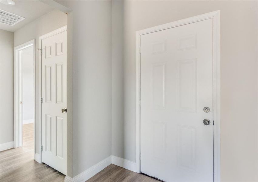 Entrance foyer with light wood-type flooring and baseboards