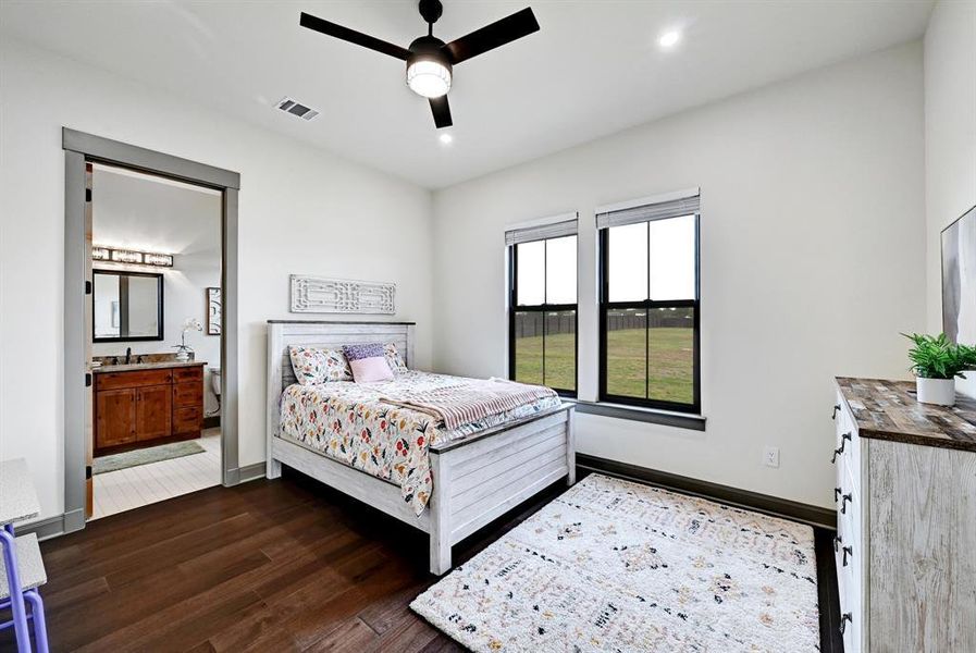 Bedroom with ensuite bath, dark wood-style floors, a ceiling fan, and recessed lighting