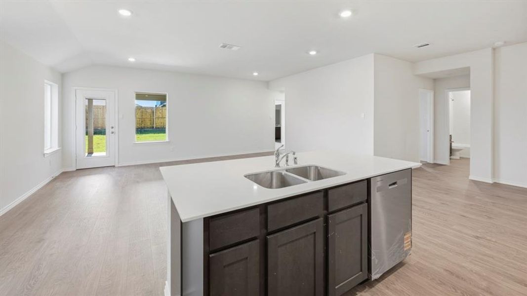 Kitchen with dishwasher, open floor plan, light wood-style flooring, recessed lighting, and a center island with sink Kitchen with dishwasher, open floor plan, light wood-style flooring, recessed lighting, and a center island with sink