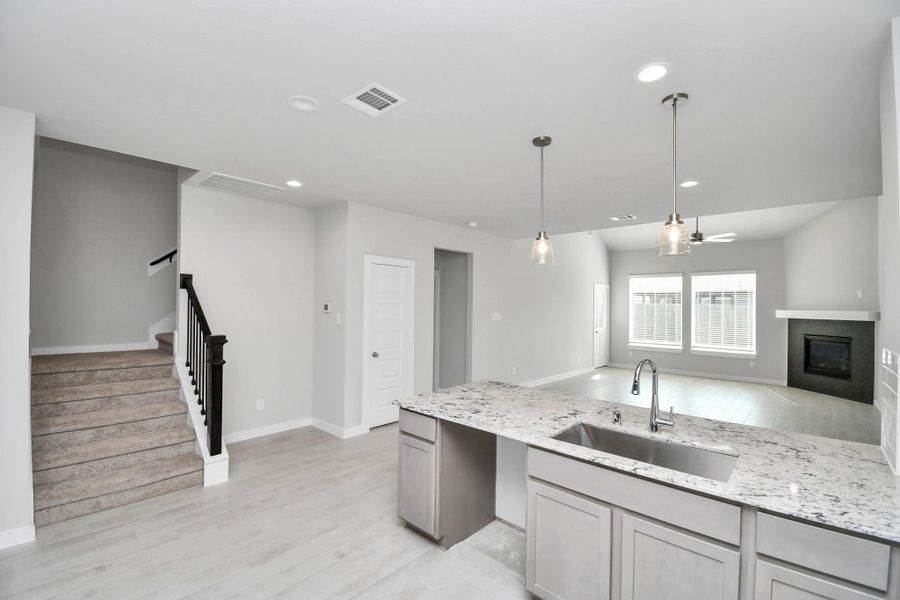 The open concept effortlessly connects the kitchen to the expansive family room, forming a perfect hub for gatherings. This seamless flow creates an inviting space where cooking and socializing come together harmoniously. Sample photo of completed home with similar floor plan. Actual colors and selections may vary.