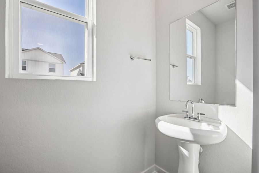 A bathroom with a sink and mirror.
