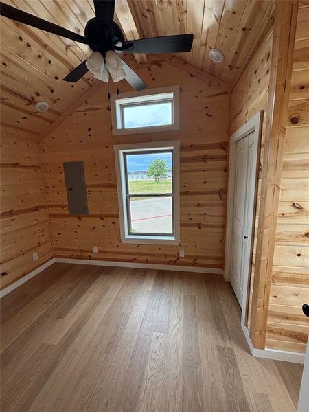 Bonus room featuring vaulted ceiling, electric panel, wooden ceiling, light wood finished floors, and ceiling fan Bonus room featuring vaulted ceiling, electric panel, wooden ceiling, light wood finished floors, and ceiling fan