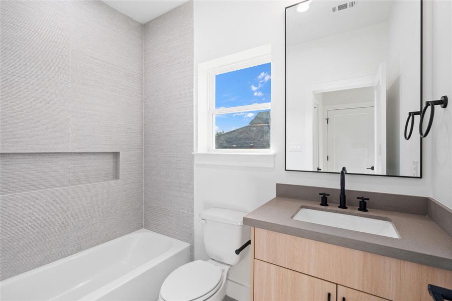 The secondary bedrooms each feature a private ensuite that mirrors the home’s sophisticated Scandinavian-inspired design. These cohesive, stylish bathrooms offer both comfort and functionality, creating a personal retreat for family or guests. The secondary bedrooms each feature a private ensuite that mirrors the home’s sophisticated Scandinavian-inspired design. These cohesive, stylish bathrooms offer both comfort and functionality, creating a personal retreat for family or guests.