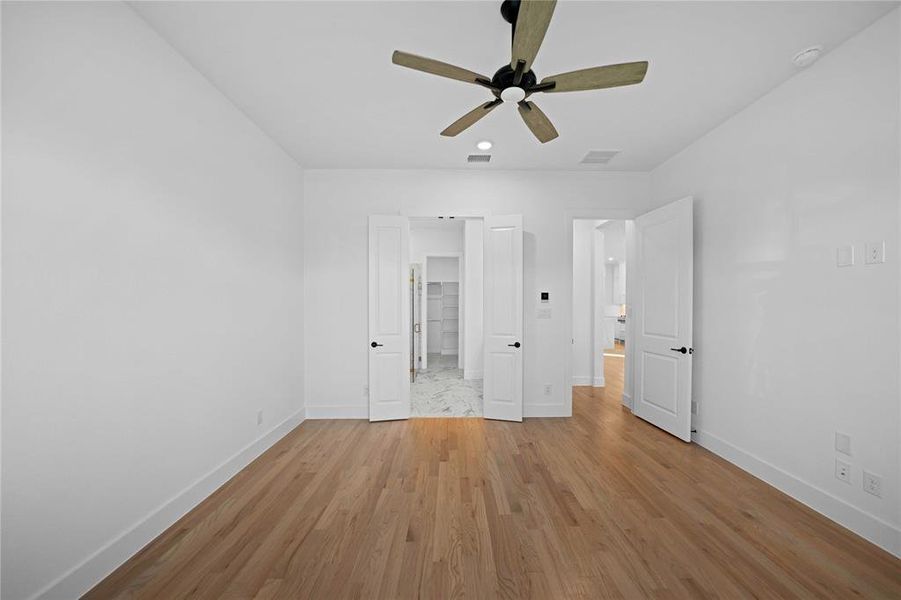 Unfurnished bedroom with light wood-style flooring, ceiling fan, and recessed lighting Unfurnished bedroom with light wood-style flooring, ceiling fan, and recessed lighting