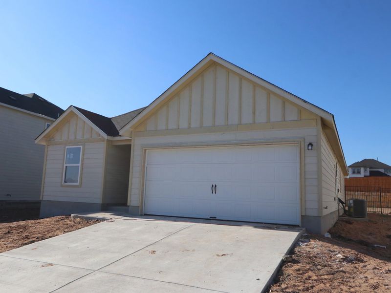 Front exterior of a new home in Cascades at Onion Creek, Austin, TX, highlighting curb appeal (Image 2).