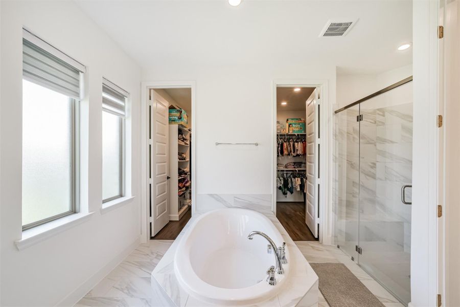 Soaking tub and separate his-and-hers closets. Soaking tub and separate his-and-hers closets.