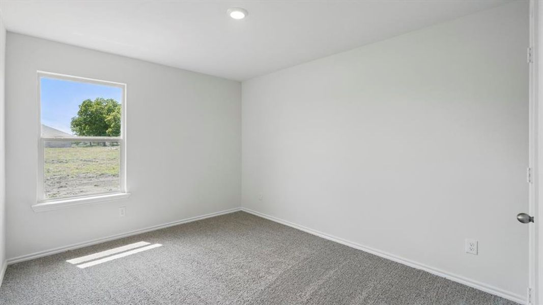 Empty room with carpet and baseboards