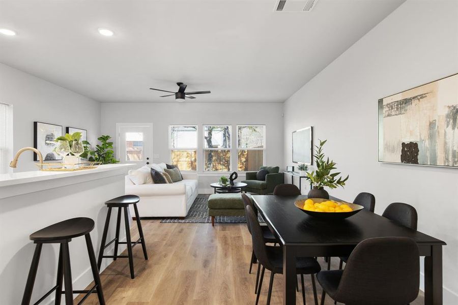 Dining room featuring light wood-type flooring, visible vents, a ceiling fan, and recessed lighting