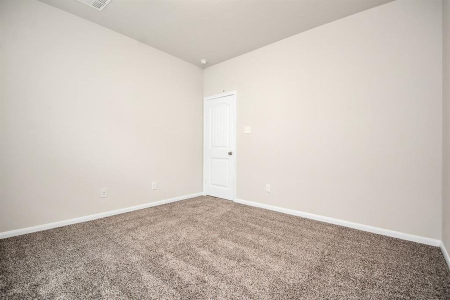 This inviting second bedroom offers flexibility and comfort. Easily envision this room as a tranquil guest space, a dedicated home office, a creative studio, or a relaxing personal retreat – the possibilities are endless! **This image is from another Saratoga Home with similar floor plan and finishes, not the Brittany floorplan.**