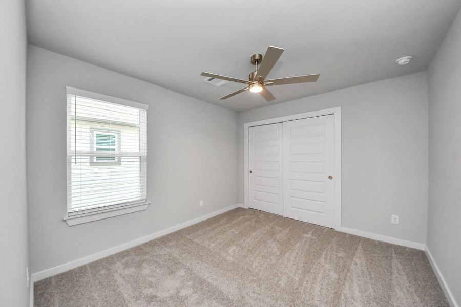 Secondary bedroom features plush carpeting, large windows that let in plenty of natural light, bright paint, and spacious closets. Secondary bedroom features plush carpeting, large windows that let in plenty of natural light, bright paint, and spacious closets.