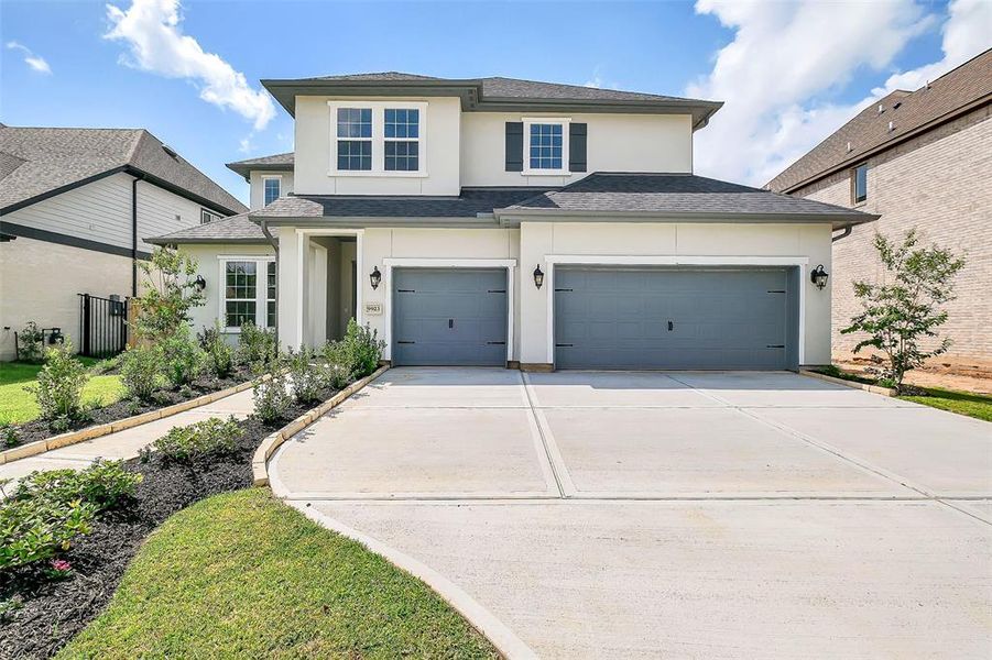 Front exterior of a new home in Sienna 65', Missouri City, TX, highlighting curb appeal (Image 23). Front exterior of a new home in Sienna 65', Missouri City, TX, highlighting curb appeal (Image 23).