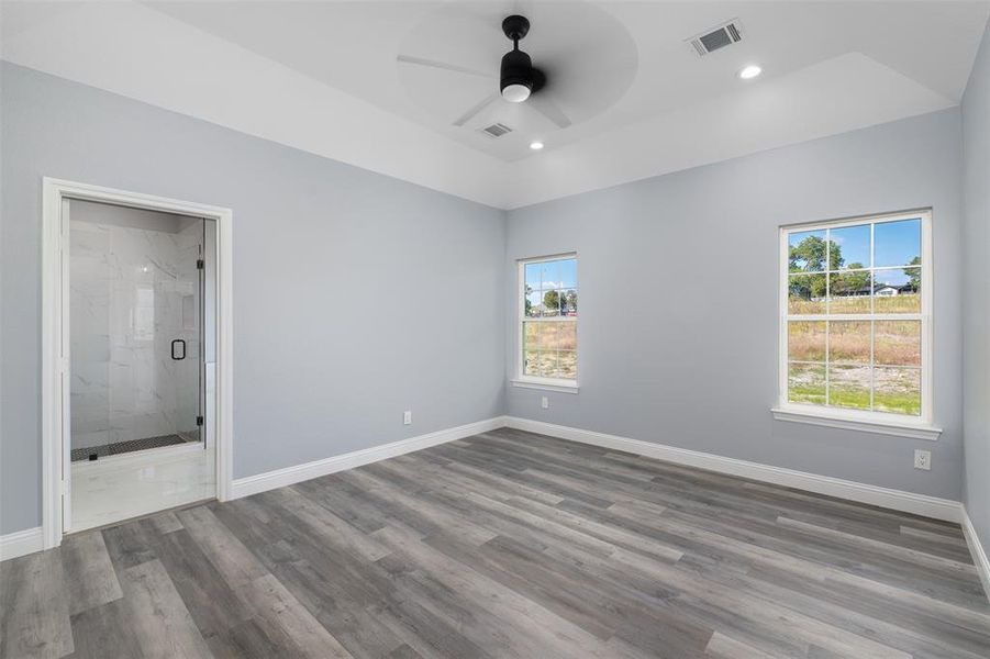 Unfurnished bedroom featuring a ceiling fan, dark wood-style flooring, recessed lighting, and ensuite bathroom Unfurnished bedroom featuring a ceiling fan, dark wood-style flooring, recessed lighting, and ensuite bathroom