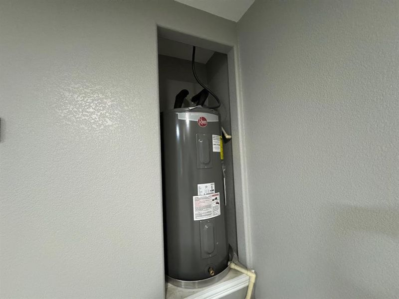 Utility room featuring electric water heater