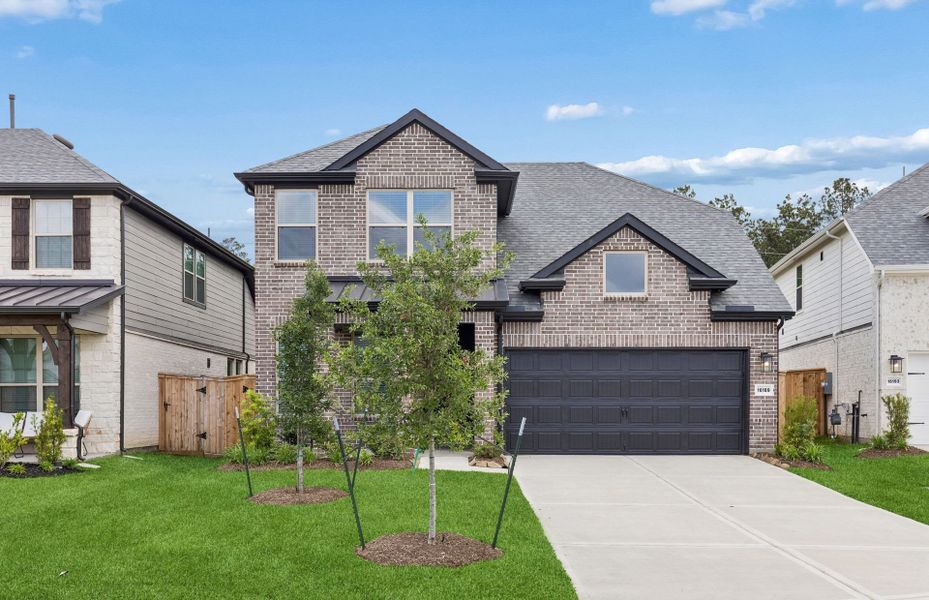 Front exterior of a new home in Mavera, Conroe, TX, highlighting curb appeal (Image 1). Front exterior of a new home in Mavera, Conroe, TX, highlighting curb appeal (Image 1).