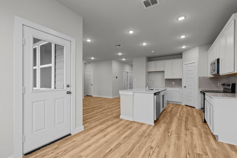 A kitchen with white cabinets. A kitchen with white cabinets.