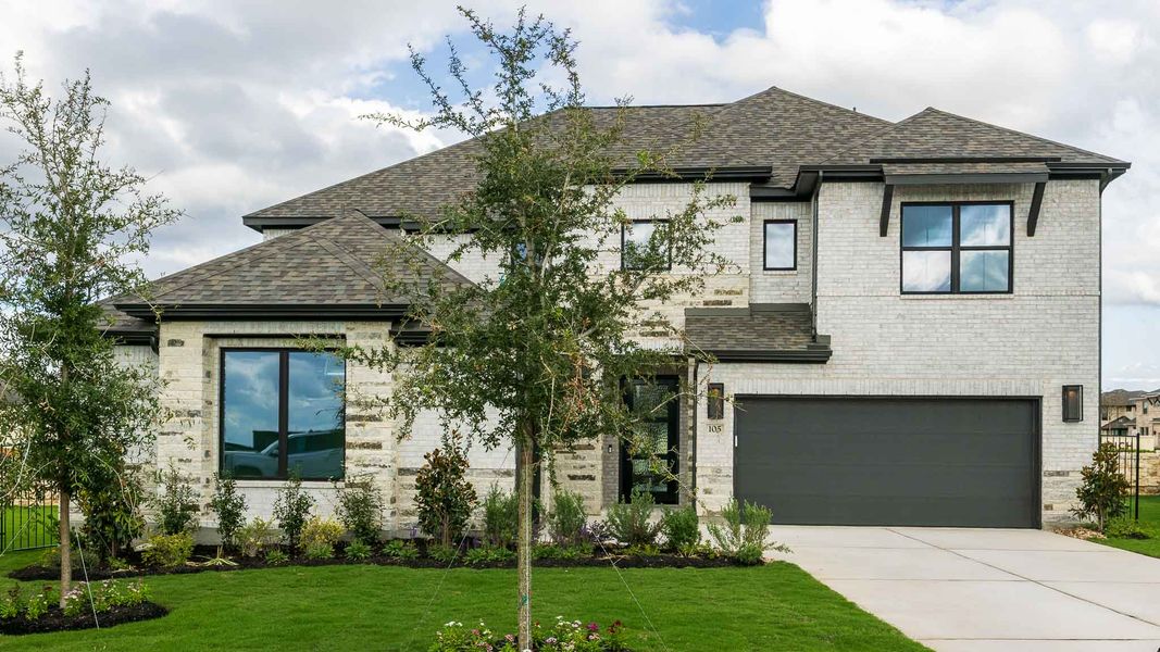 Front exterior of a new home in Santa Rita Ranch - Eldorado, Liberty Hill, TX, highlighting curb appeal (Image 1). Front exterior of a new home in Santa Rita Ranch - Eldorado, Liberty Hill, TX, highlighting curb appeal (Image 1).