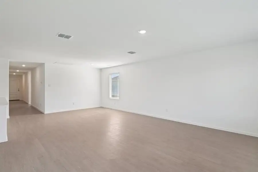 Spare room with light wood-style floors and recessed lighting