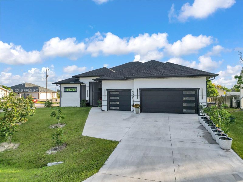 Front exterior of a new home in , Lehigh Acres, FL, highlighting curb appeal (Image 1). Front exterior of a new home in , Lehigh Acres, FL, highlighting curb appeal (Image 1).
