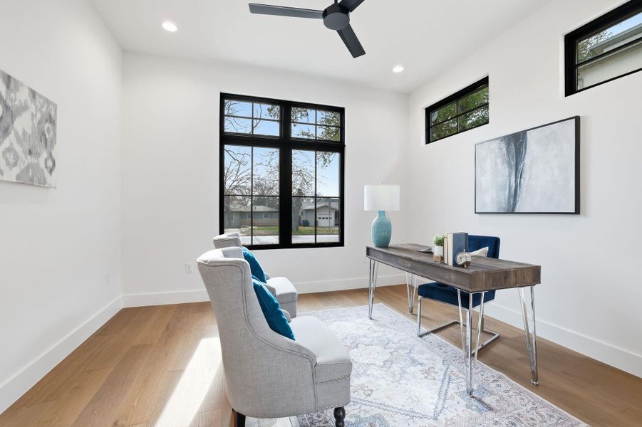 Office space featuring a ceiling fan, light wood-type flooring, and recessed lighting