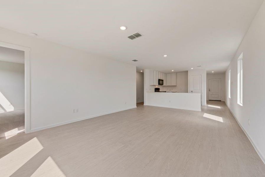 Unfurnished living room with recessed lighting and light wood-type flooring